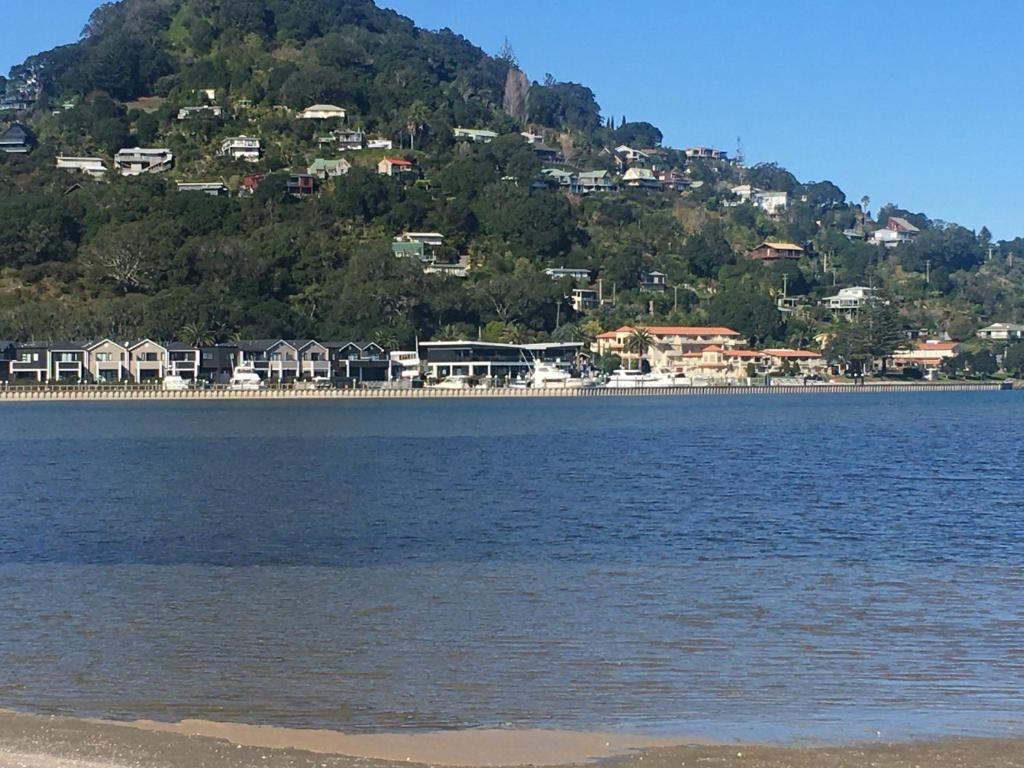 a large body of water with houses on a hill at Tairua Marina Villa in Tairua