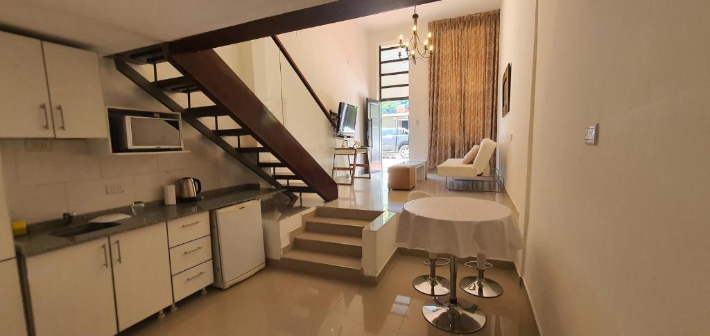 a kitchen with a staircase and a table in a room at Solares, Departamento zona centro in La Rioja