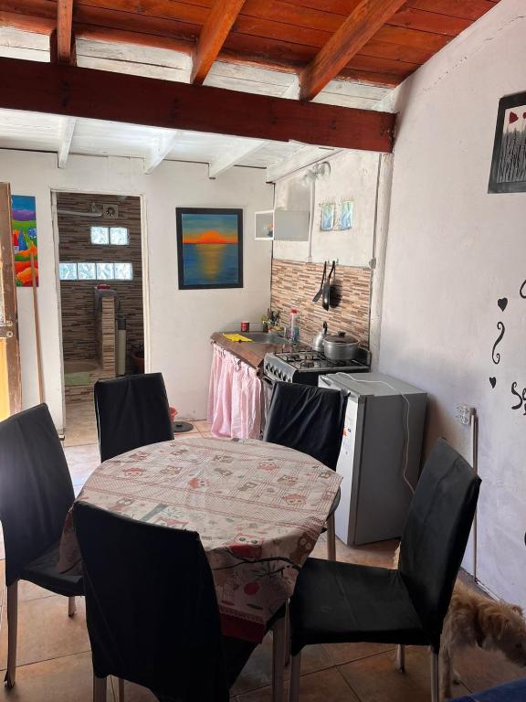 a kitchen with a table with chairs and a stove at El remanso in Mar del Plata