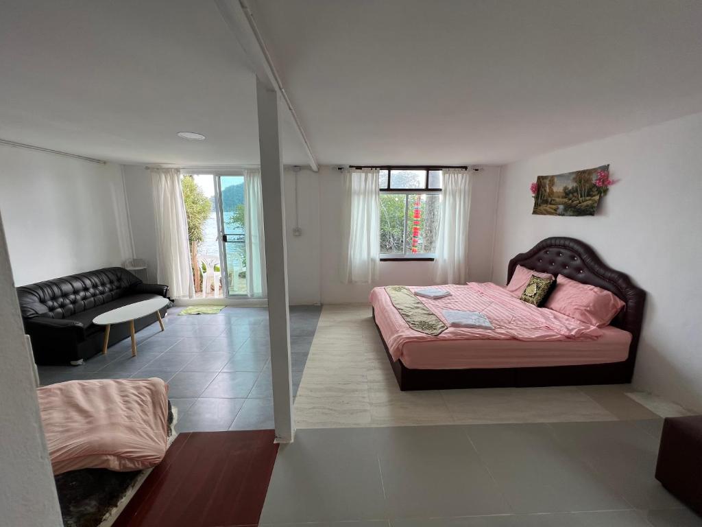 a bedroom with a bed and a living room at Rasta view Bangalows in Ko Chang