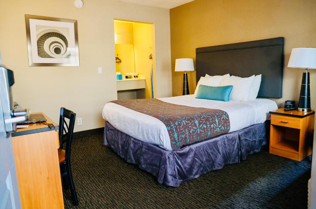 A bed or beds in a room at City Center Inn and Suites