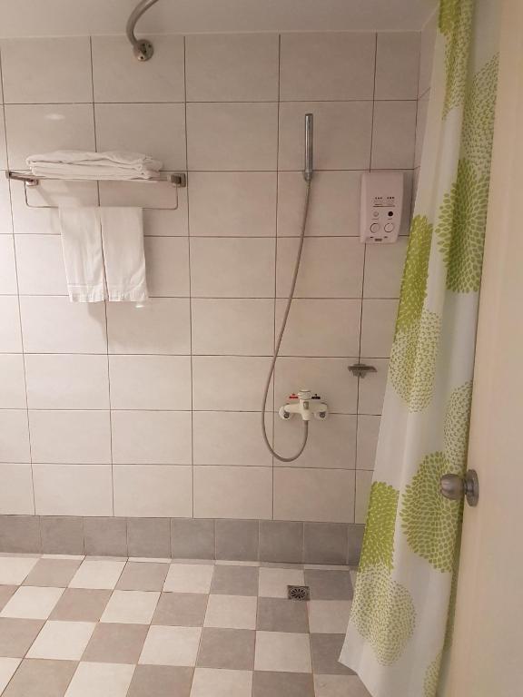 a bathroom with a shower with a shower curtain at King&#39;s Resort &amp; Spa in Tai&#39;an