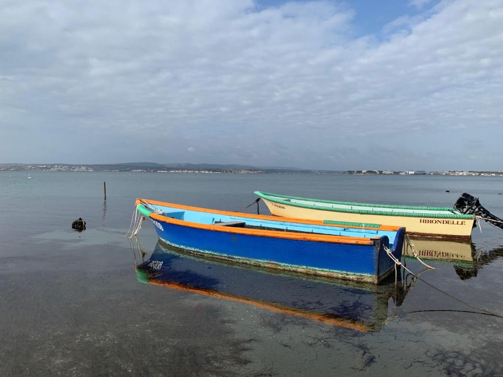 two boats sitting in the water on a beach at Studio Sète, 1 pièce, 4 personnes - FR-1-338-406 in Sète