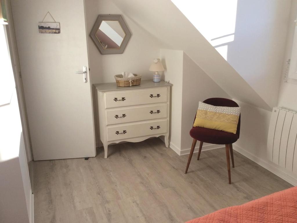 a stair room with a dresser and a chair at Maison Le Tour-du-Parc, 4 pièces, 6 personnes - FR-1-639-51 in Le Tour-du-Parc