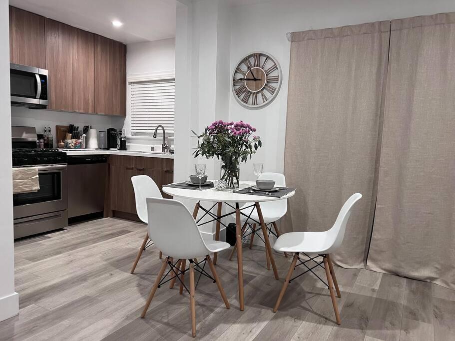 a kitchen with a white table and white chairs at Cozy 1BR 1BA apt center of LA steps from the Grove in Los Angeles