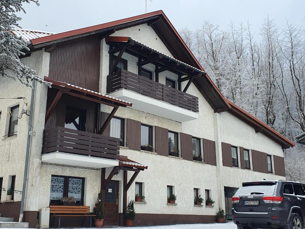 a building with a balcony on the side of it at Apartment with panoramic view in Brotterode-Trusetal
