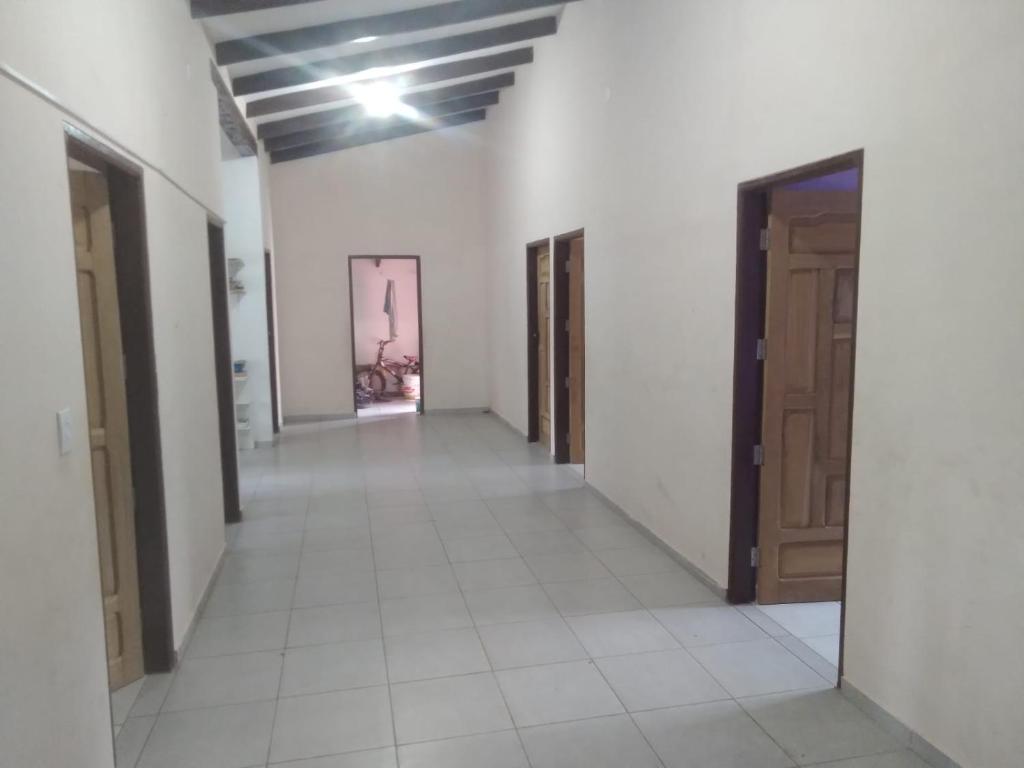 an empty hallway with doors in a building at Casa San José in San José de Chiquitos