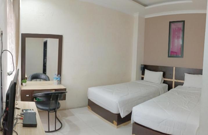 Postel nebo postele na pokoji v ubytování KHARIZ HOTEL