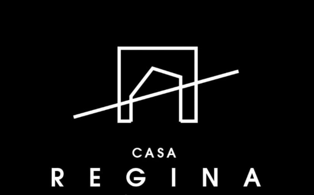 a logo for a company with a box and a sign at CASA REGINA Hotel - Cantina SMA in San Miguel de Allende