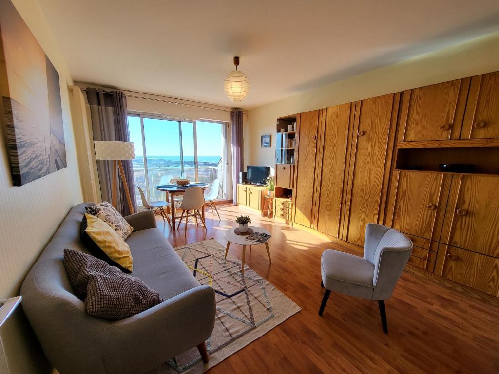 un salon avec un canapé, des chaises et une table dans l'établissement Studio proche plage avec parking privatif et balcon - FR-1-92-615, à Les Sables-dʼOlonne