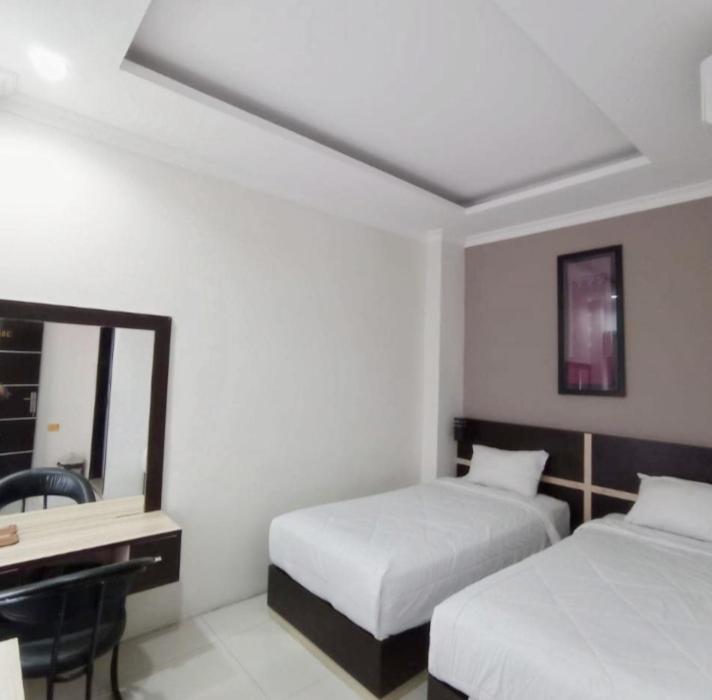 Postel nebo postele na pokoji v ubytování KHARIZ HOTEL