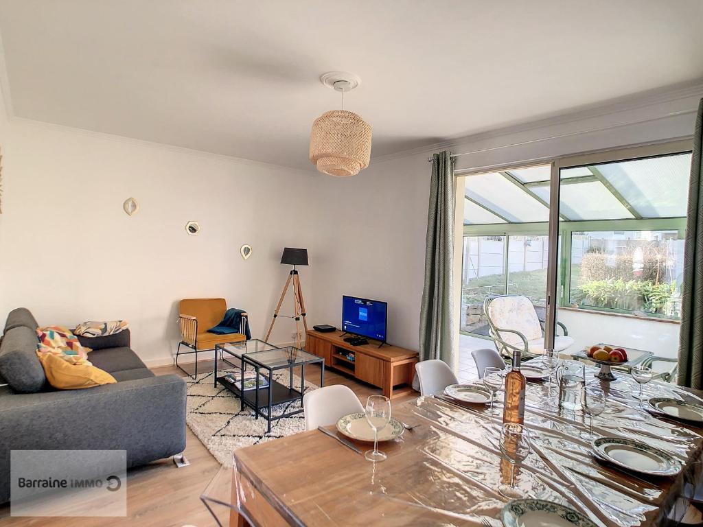 a living room with a couch and a table at Maison Camaret-sur-Mer, 7 pièces, 8 personnes - FR-1-370-82 in Camaret-sur-Mer