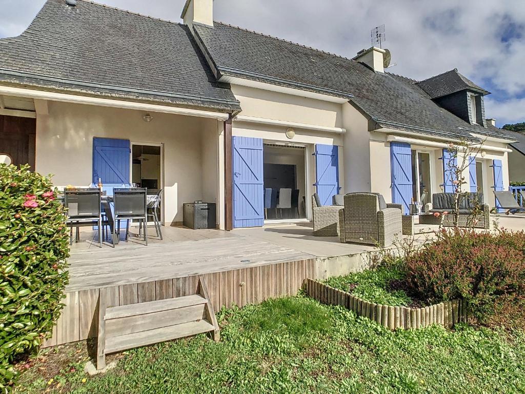 a house with a deck with a table and chairs at Maison Crozon, 5 pièces, 8 personnes - FR-1-370-81 in Crozon