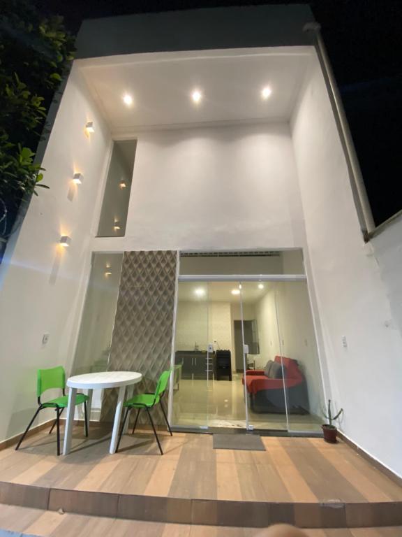 a patio with a table and chairs and a couch at Casa praia 99 in Serra