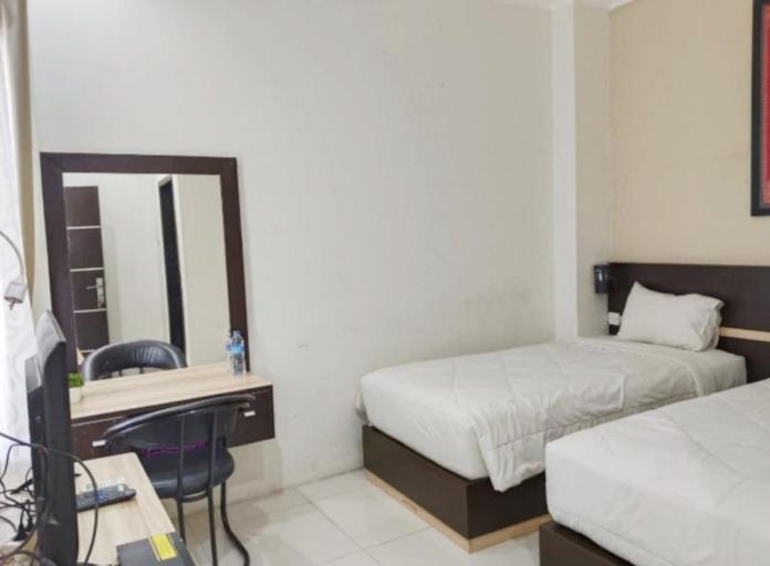 Postel nebo postele na pokoji v ubytování KHARIZ HOTEL