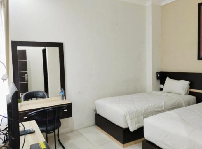 Postel nebo postele na pokoji v ubytování KHARIZ HOTEL