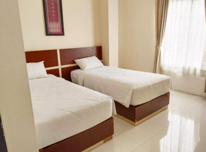 Postel nebo postele na pokoji v ubytování KHARIZ HOTEL