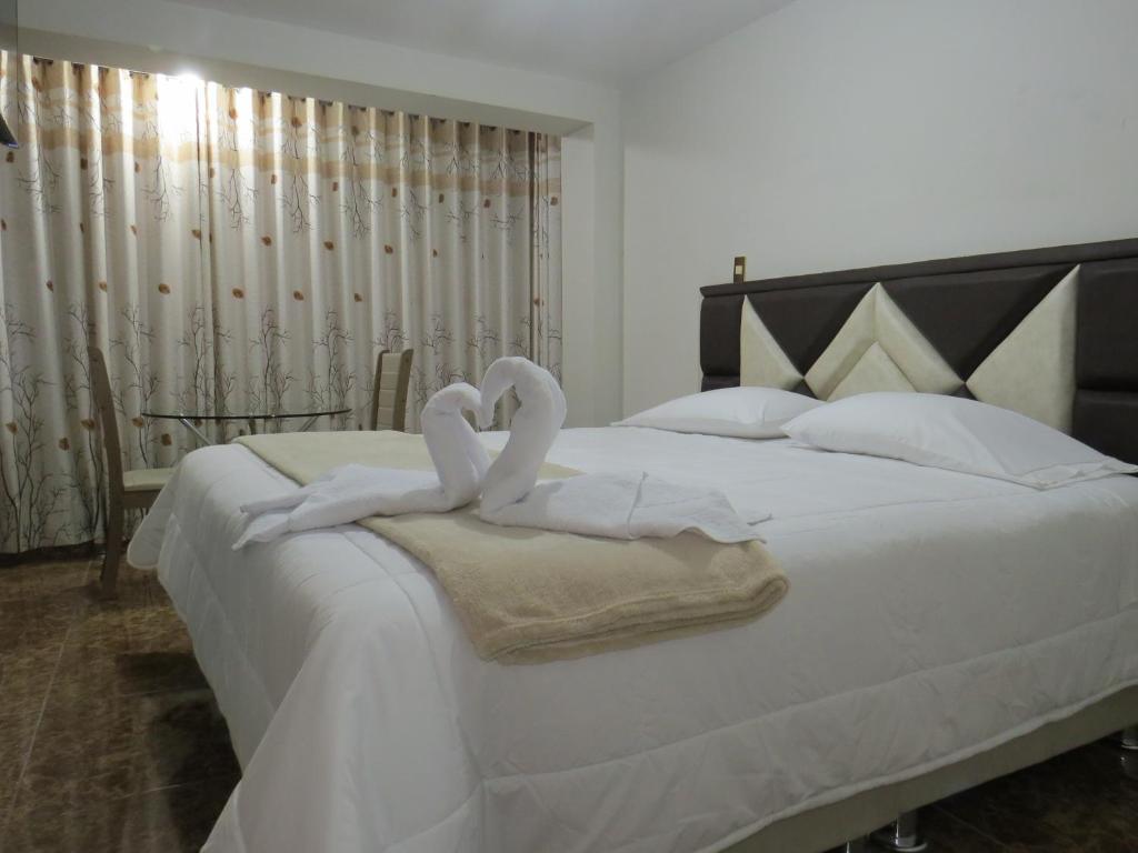 Un pat sau paturi într-o cameră la Hospedaje EL RINCONCITO II