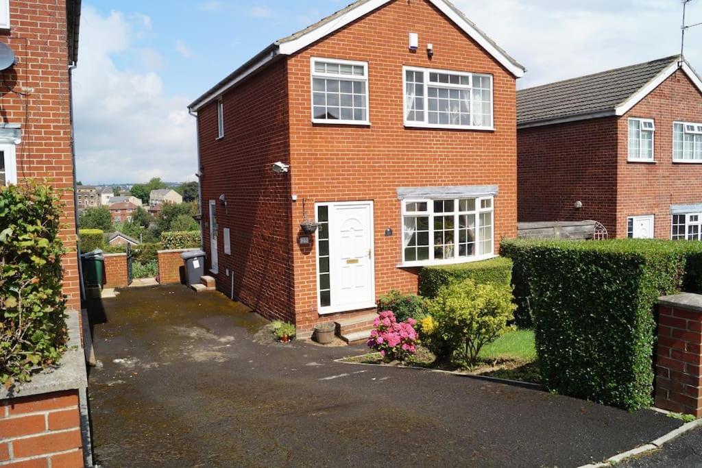 a brick house with a white door and a driveway at 3 Bed House with Exceptional view in Batley