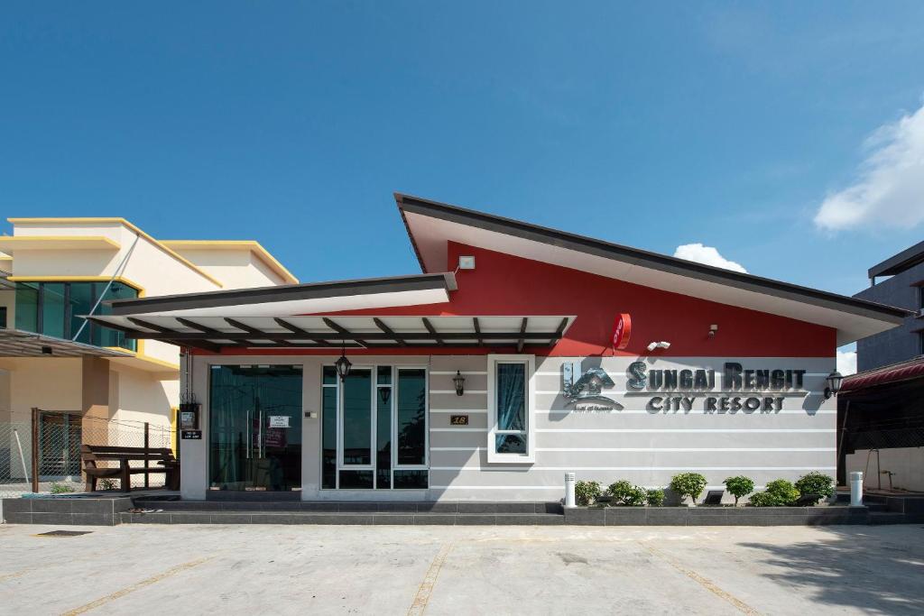 a red and white building with a sign on it at Sg Rengit City Resort 2 in Kampung Sungai Rengit