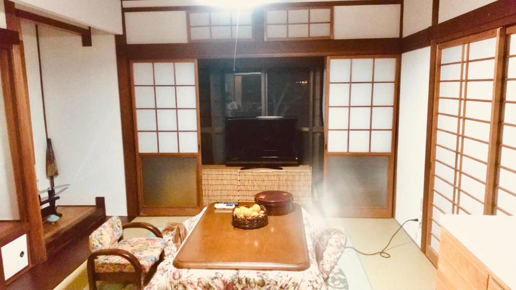 Una habitación con una mesa con un pastel. en Guest House Nagasaki 1 御船蔵の我が家 1, en Nagasaki