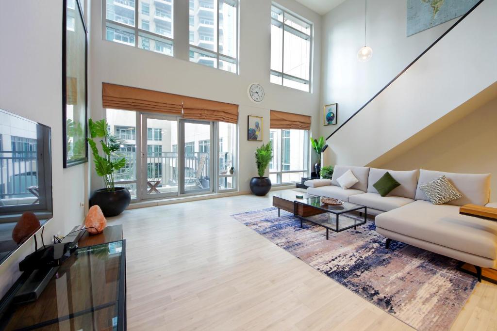 a living room with a couch and a table at New Arabian Loft Central Downtown in Dubai