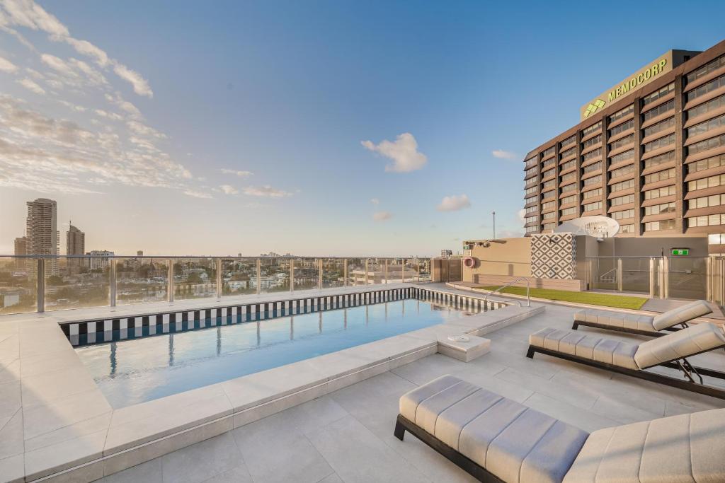 a swimming pool on the roof of a hotel at Oaks Sydney Hyde Park Suites in Sydney