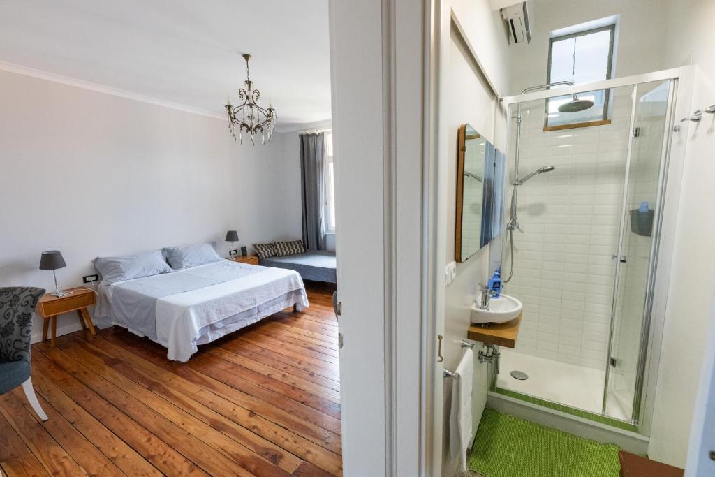a bedroom with a bed and a bathroom at The Liberty Terrace in Udine