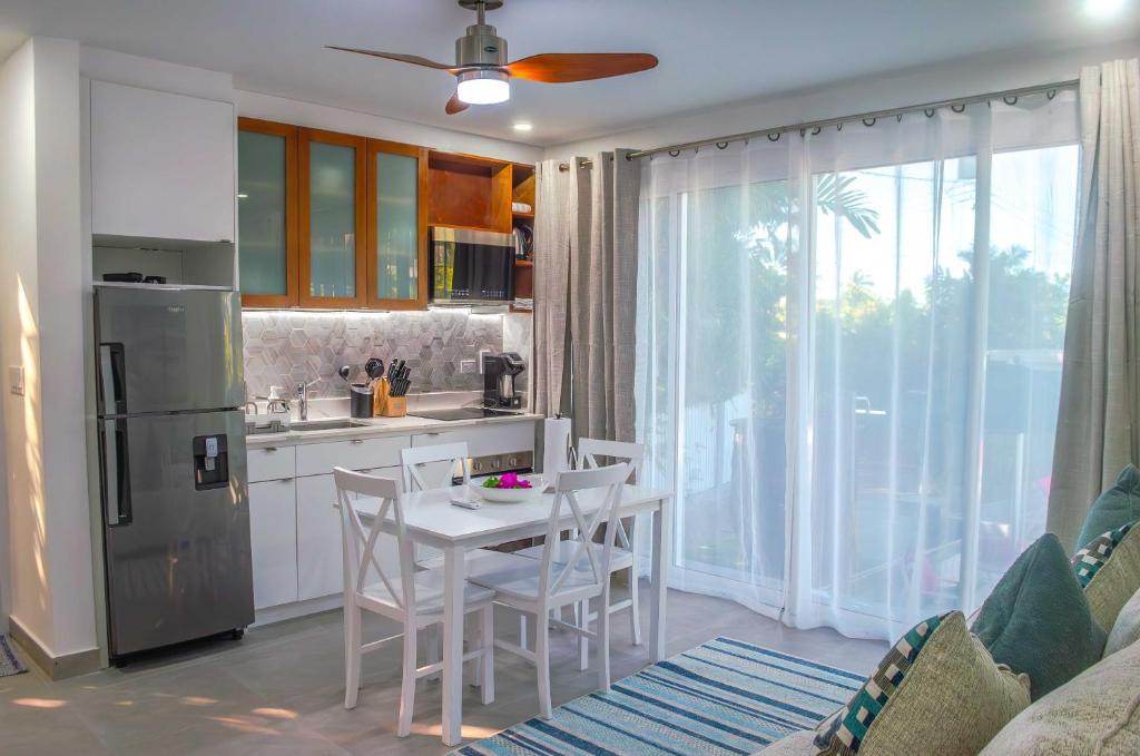 a kitchen with a table and chairs in a room at The Palms Resort in Saint James