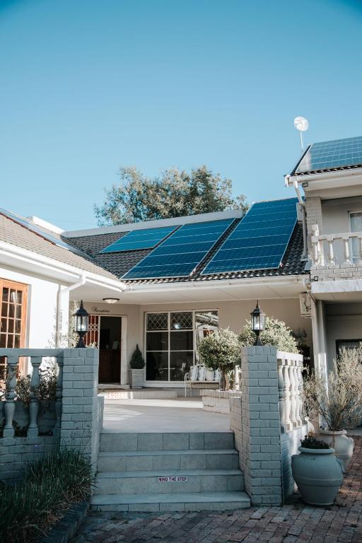 a house with solar panels on the roof at The Symphony Guest House in Queenstown
