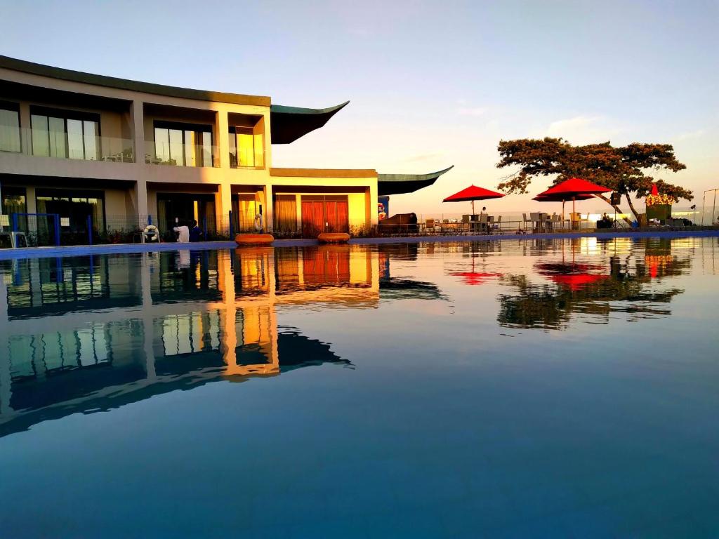 a building with a pool of water in front of it at Aquarius Kigo Resort in Kigo
