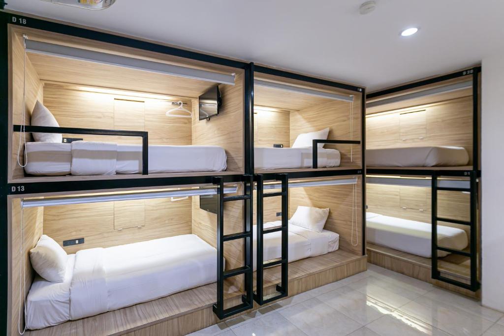a room with four bunk beds in it at The Bedrooms Hostel Pattaya in Pattaya Central