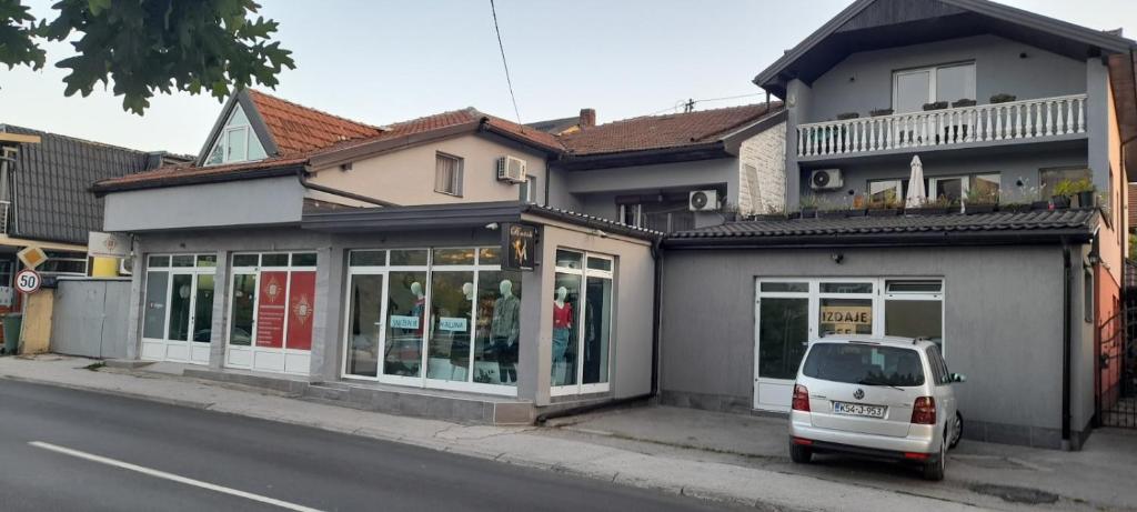 a white car parked in front of a building at Aura City 2 in Visoko