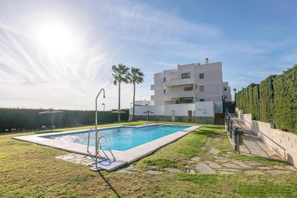 a swimming pool in front of a building at Paraiso Costero - Adults Only - in Conil de la Frontera