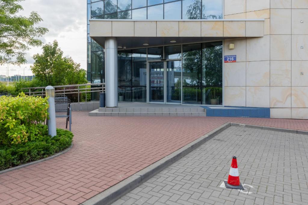a traffic cone sitting in front of a building at Zlatarooms 310 in Warsaw