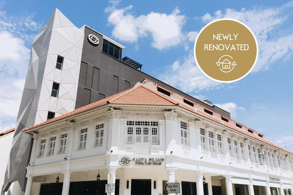 a white building with a clock tower on top of it at Santa Grand Hotel East Coast a NuVe Group Collection in Singapore