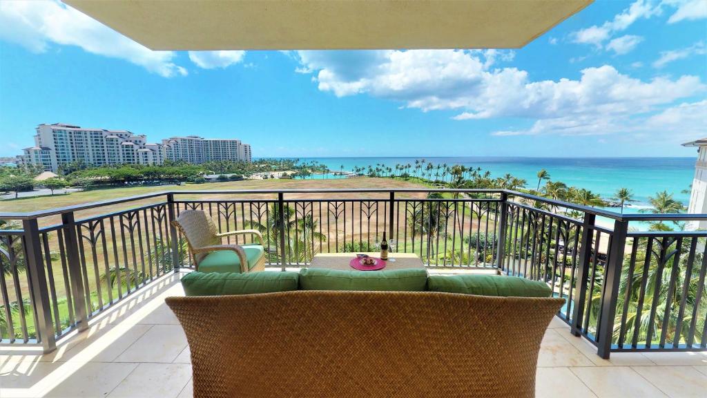 a balcony with a table and chairs and the ocean at Ko Olina Beach Villas B701 in Kapolei