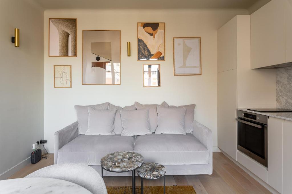 a living room with a white couch and a table at The Carla Suite Eiffel Tower View in Paris