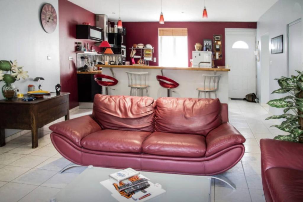 a brown leather couch in a living room at MAISON CREUZIER - Vichy à 5min - Jardin - BBQ - Calme in Creuzier-le-Vieux