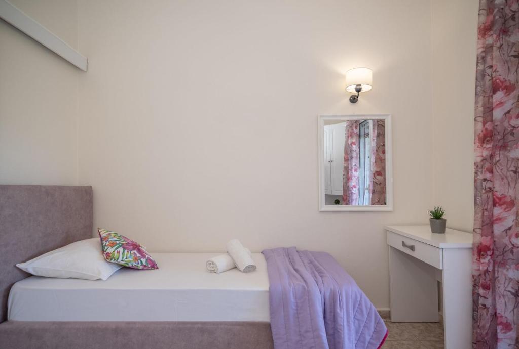 Postel nebo postele na pokoji v ubytování Kamara Apartments