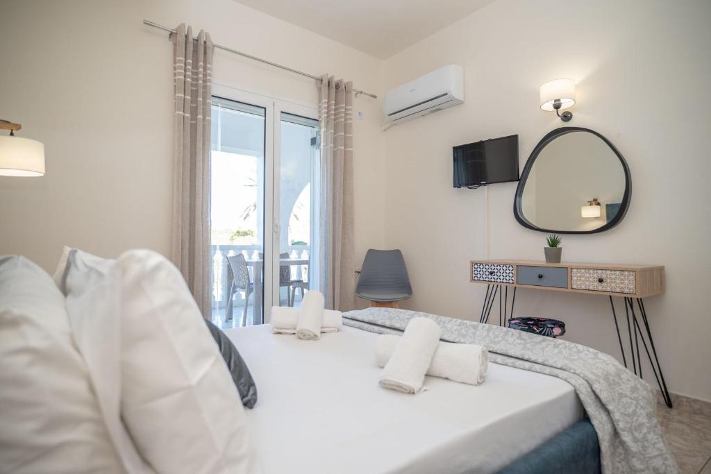 Postel nebo postele na pokoji v ubytování Kamara Apartments