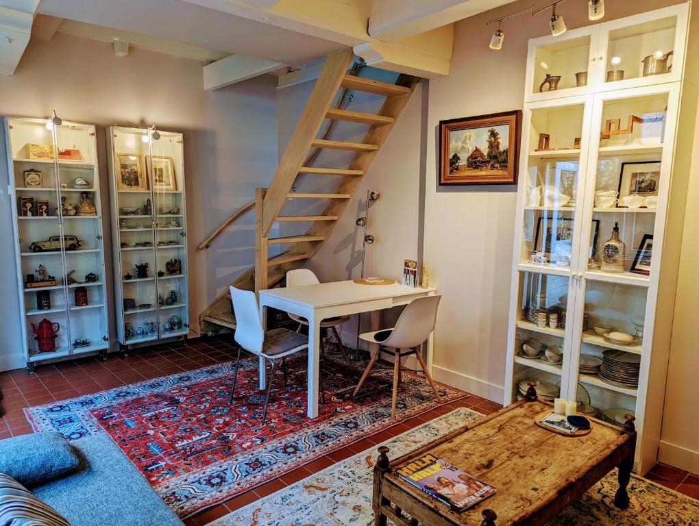 uma sala de estar com uma mesa e uma escada em Het Pakhuis Haarlem em Haarlem