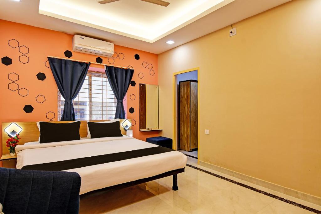 a bedroom with a bed and a window at Emerald Inn in Bhubaneshwar