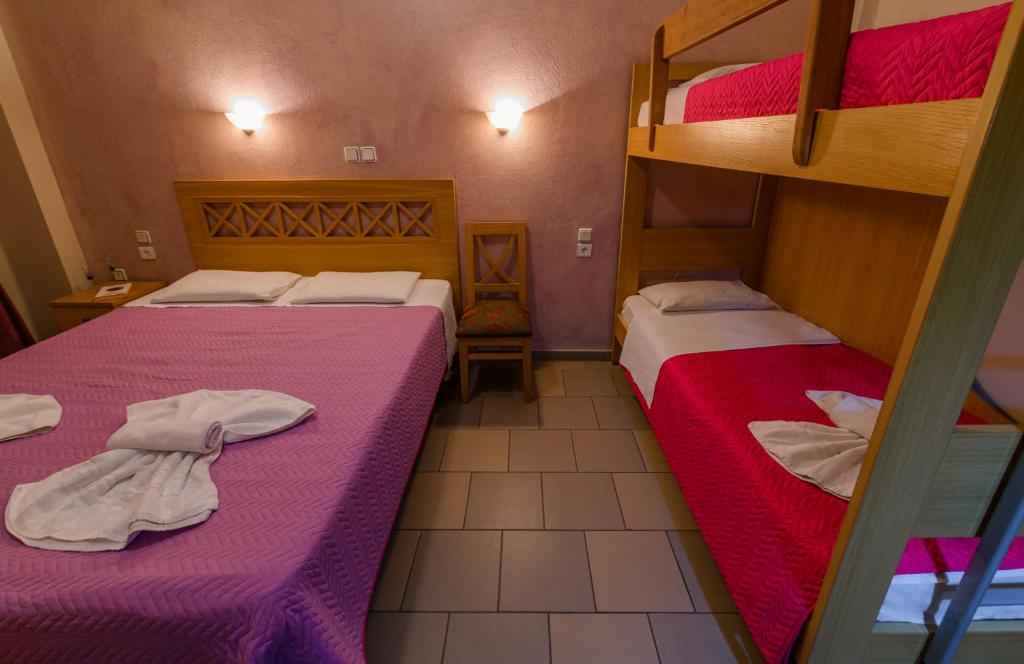 A bed or beds in a room at Agali Hotel