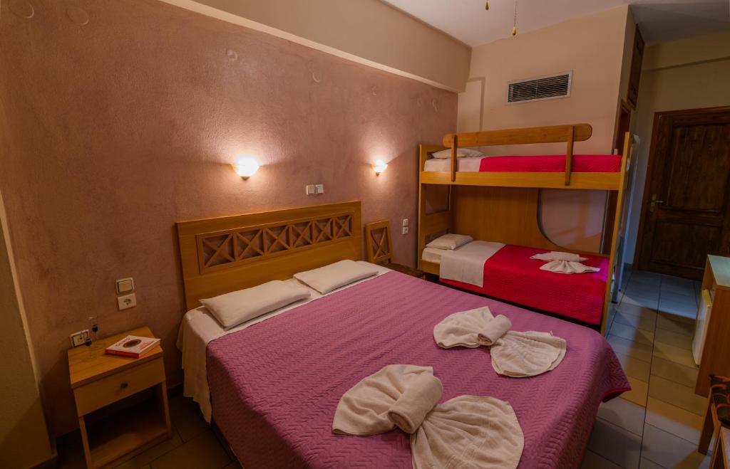 A bed or beds in a room at Agali Hotel