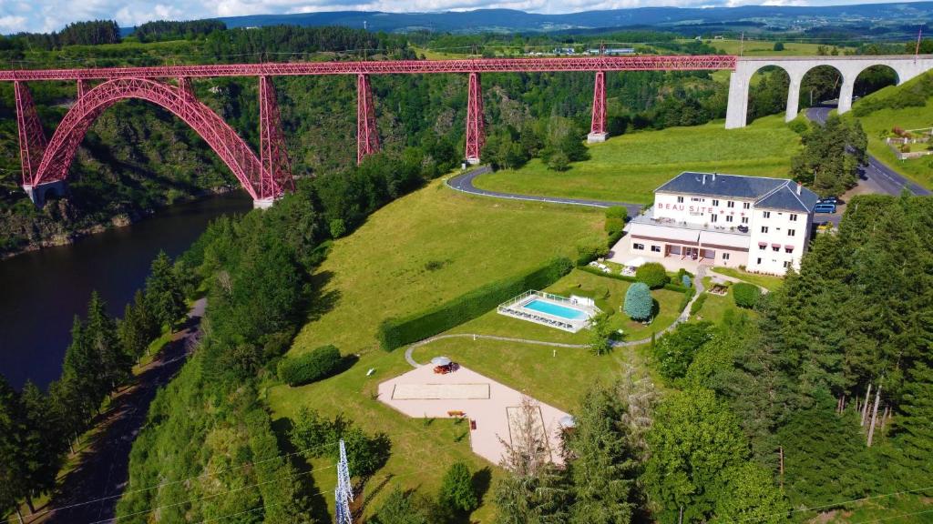 an aerial view of a bridge over a river at Logis Hôtel Beau Site in Loubaresse