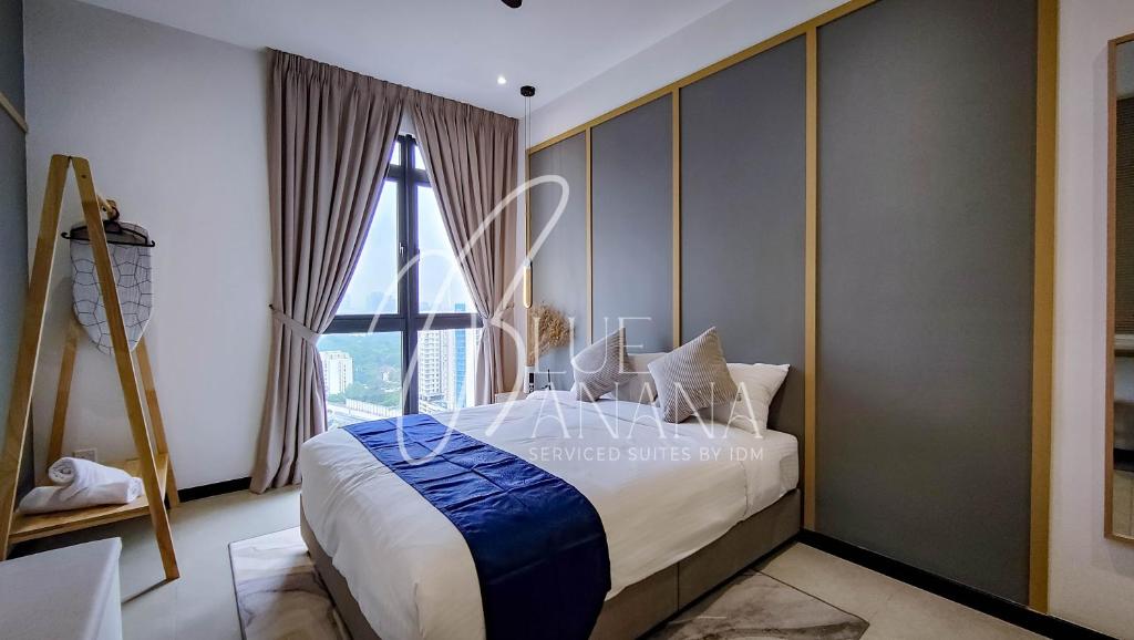 a bedroom with a large bed and a window at Neu Suites Premier Suites by BlueBanana in Kuala Lumpur