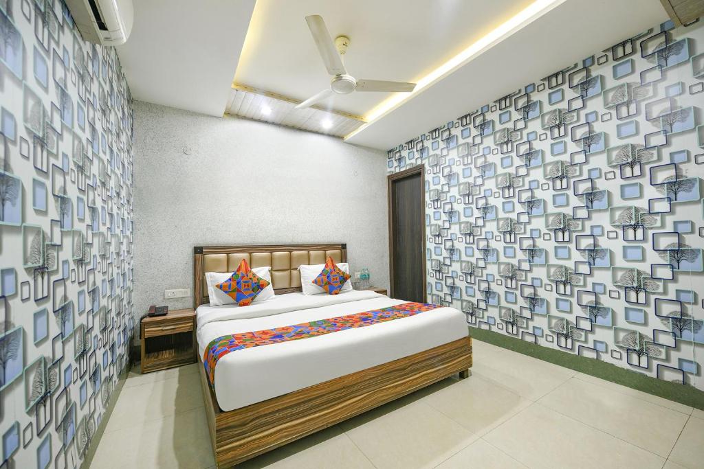 a bedroom with a large bed in a room at FabHotel Ess Pee Grand in Mohali