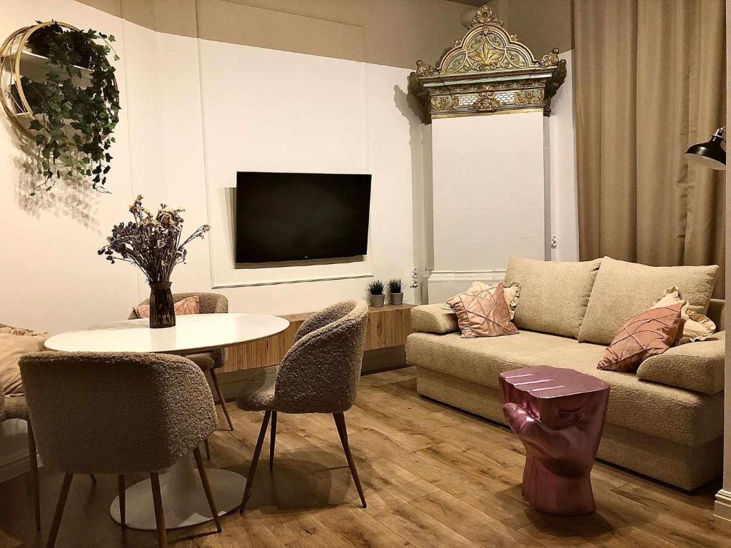 a living room with a couch and a table at Sands Sopot Apartments in Sopot