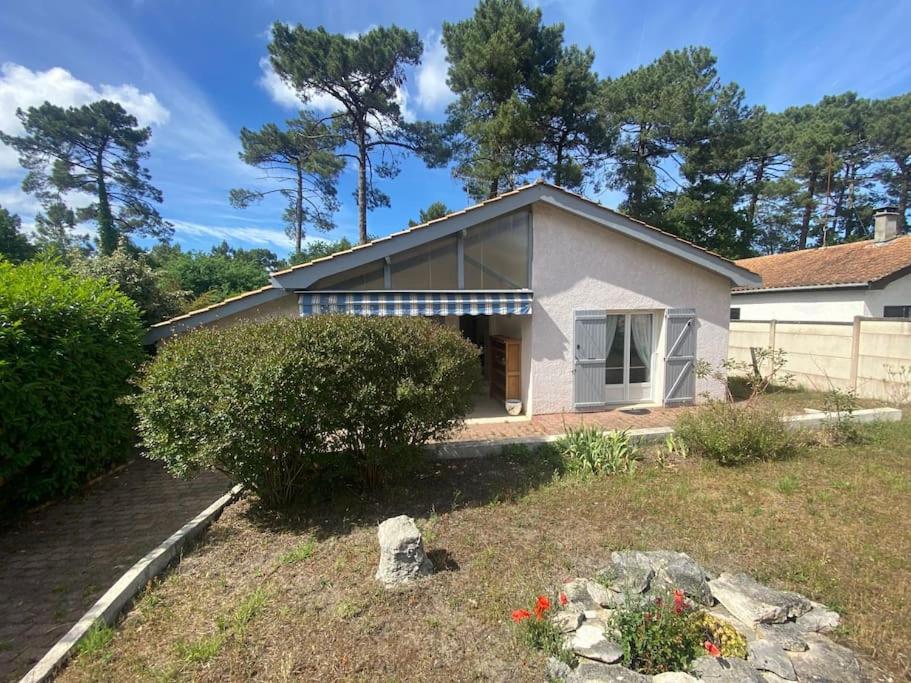 une petite maison blanche avec une cour dans l'établissement Maison agréable à La Teste-de-Buch, à La Teste-de-Buch